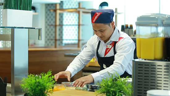 Sodexo chef preparing food behind a counter