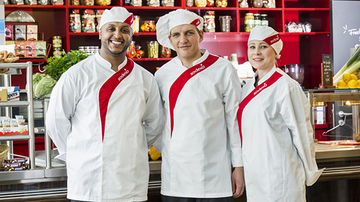 Three Sodexo chefs standing in front of a counter