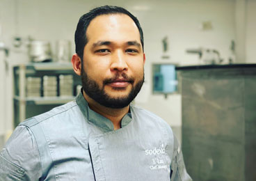 Portrait of a male chef looking at the camera in his kitchen