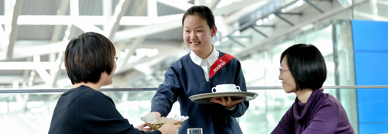 Woman serving two customers