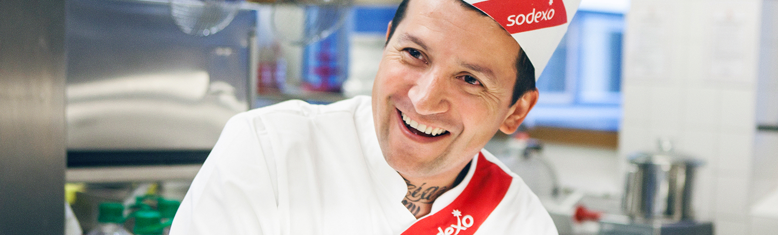 A smiling Sodexo chef in the kitchen