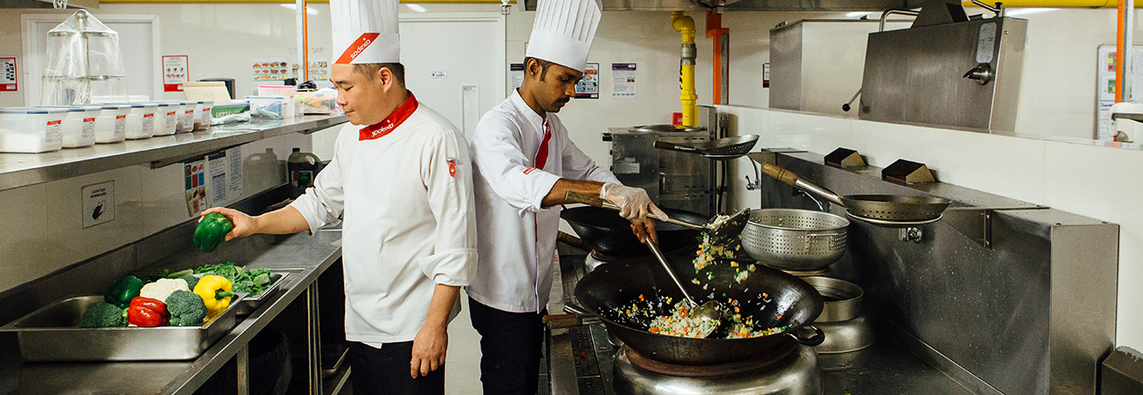 two Sodexo chefs working in a commercial kitchen