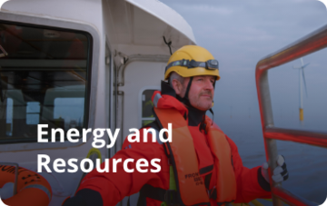 Wind turbine engineer on a boat. Text over image says: energy and resources