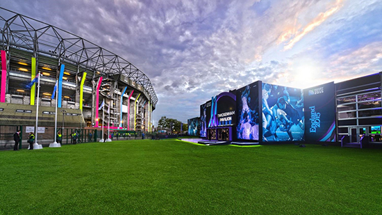 Stadium with multi-coloured flags hanging around the edge