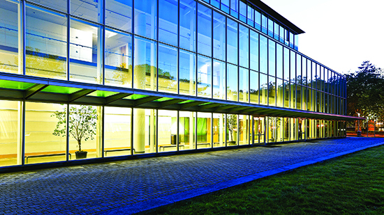 A building with lots of windows lit up at dusk